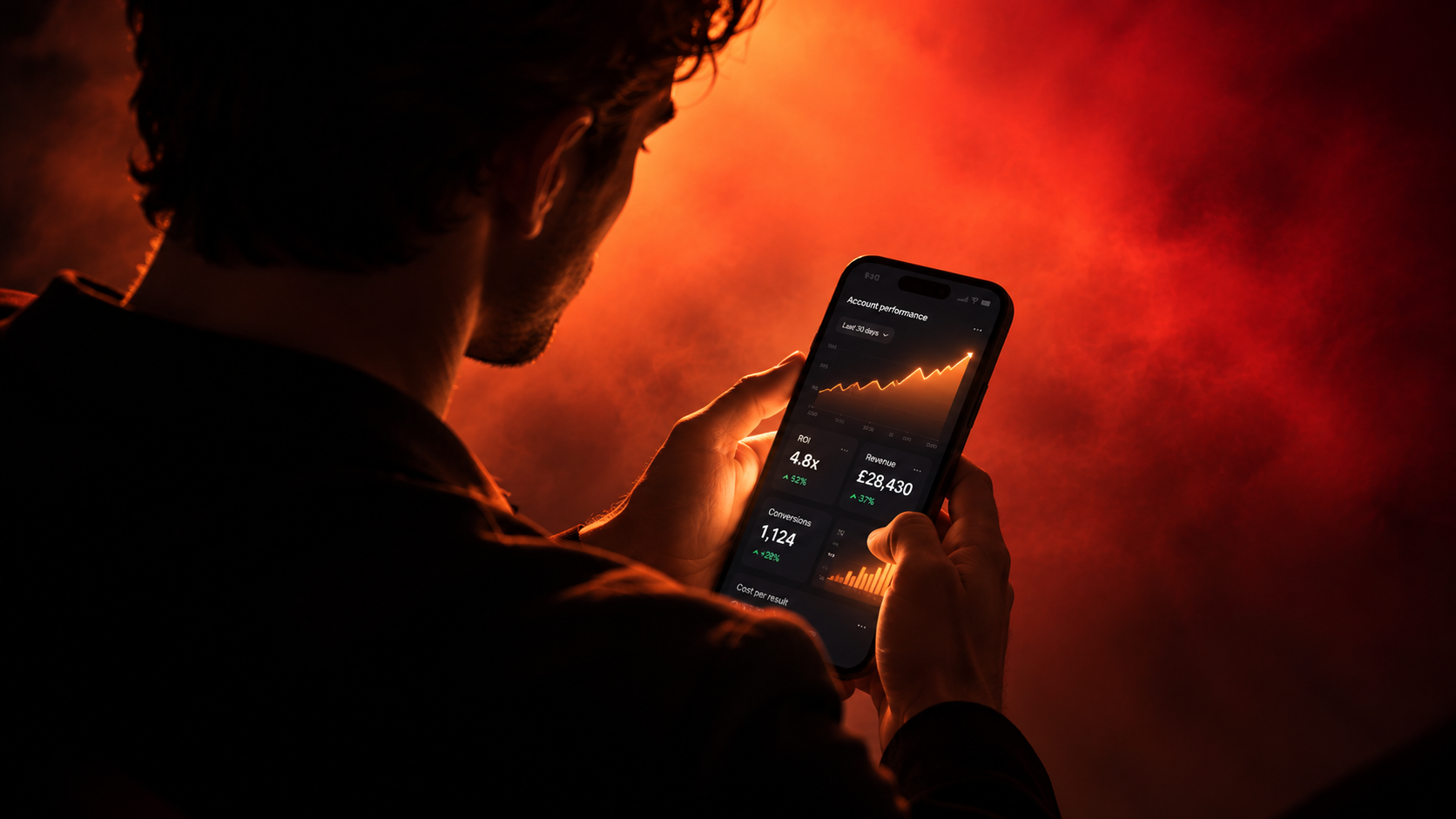 A smartphone displaying a finance dashboard, lit in warm amber against a dark background.