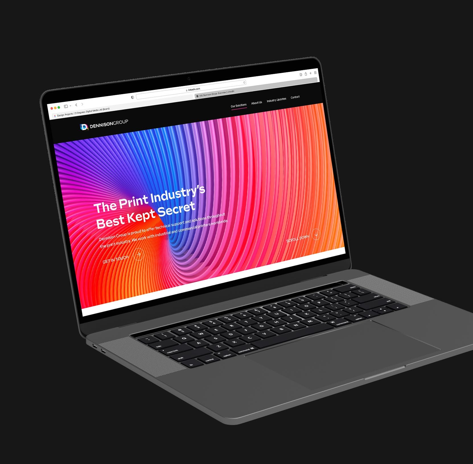 Dennison Group website homepage on a laptop.