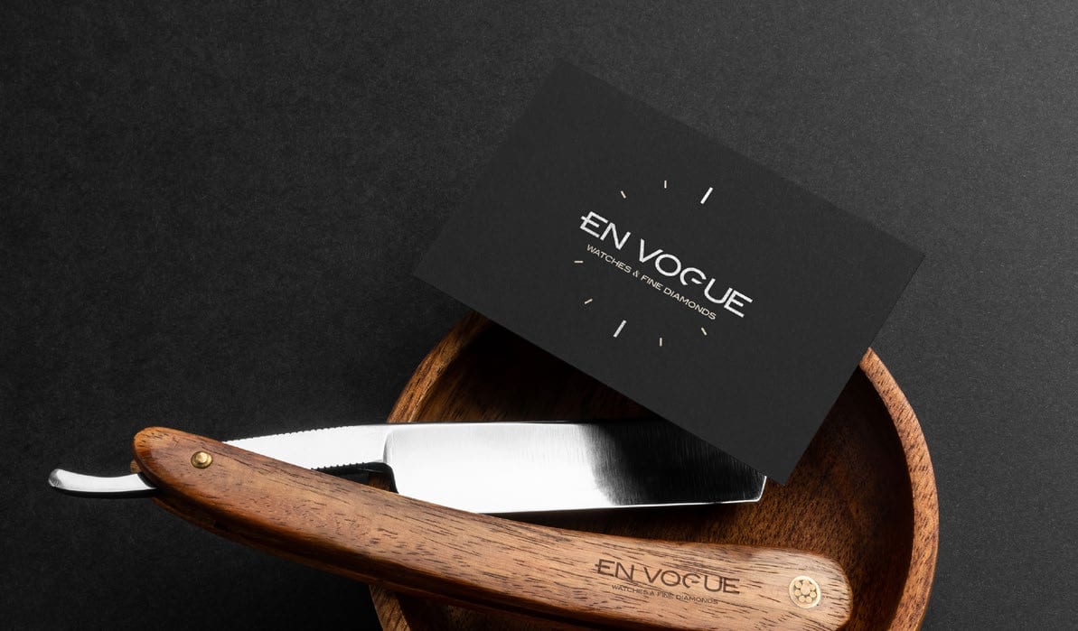 The En Vogue business card design in a dark flat-lay