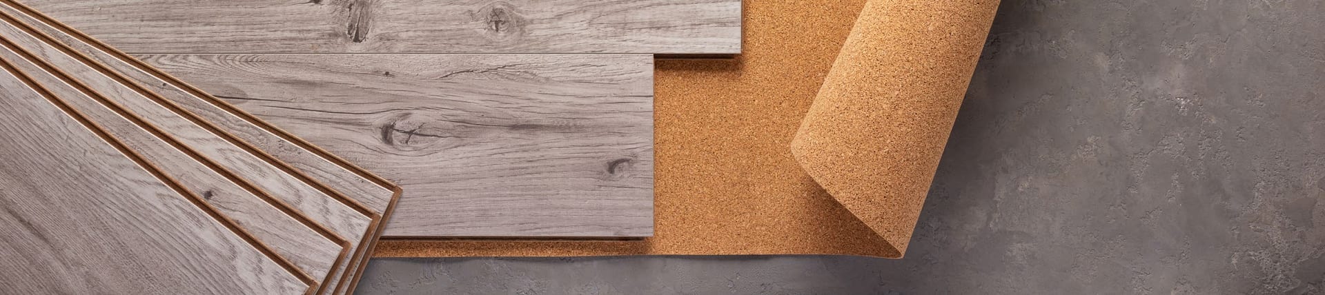 Wood and cork flooring samples laid together.