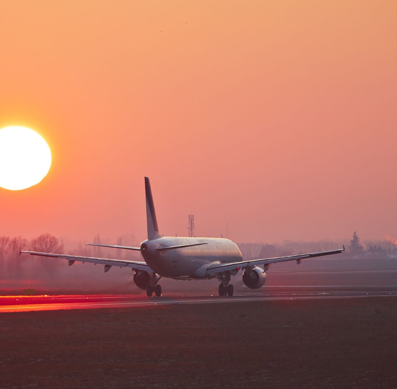 A plane on the runway at sunset, Holmes & Partners brand world.