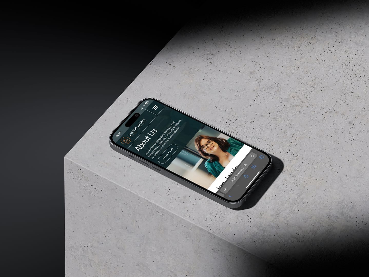 Jarvie-Khan app on a phone resting on concrete.