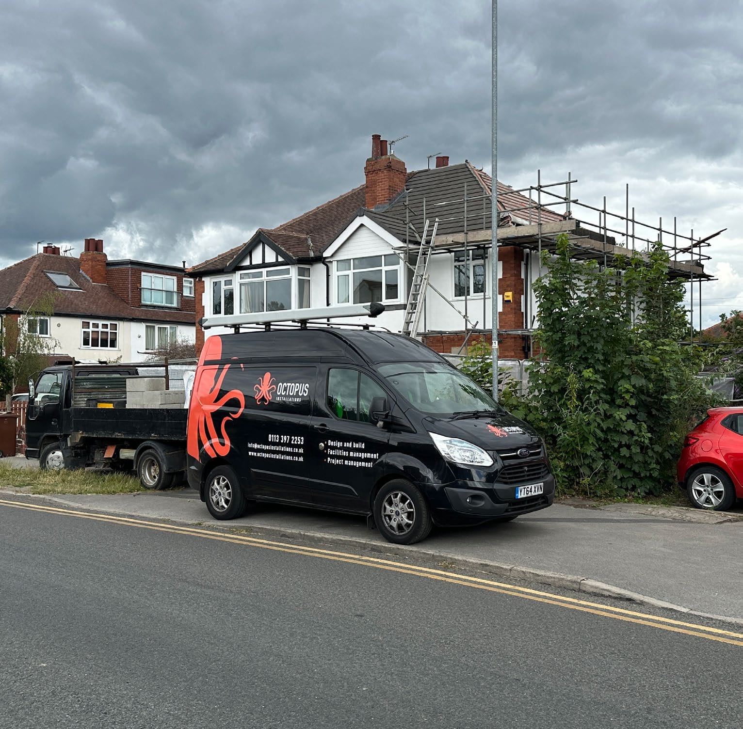 Octopus Installations branded van outside a house with scaffolding.