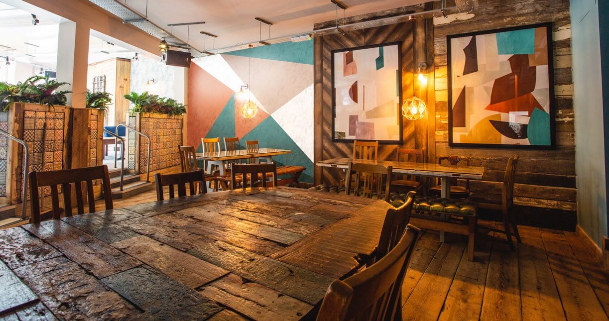 TownHouse interior, warm wood and bold wall graphics.