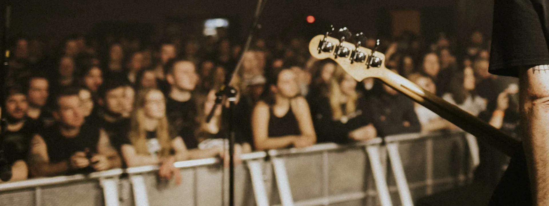 A band playing a live show at an independent music venue, Smile Bar case study image.