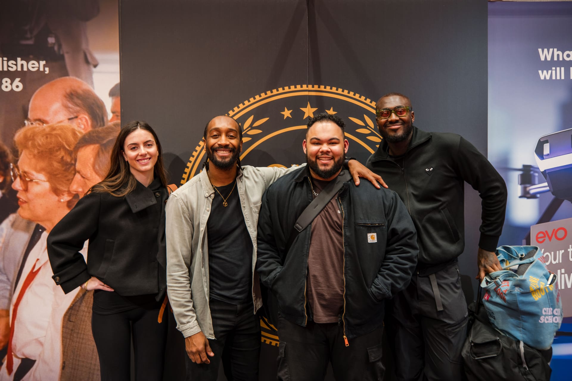 Four 21 Degrees team members smiling together at an industry event.
