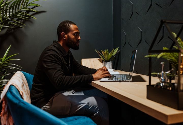 A 21 Degrees team member working at a desk in the studio.