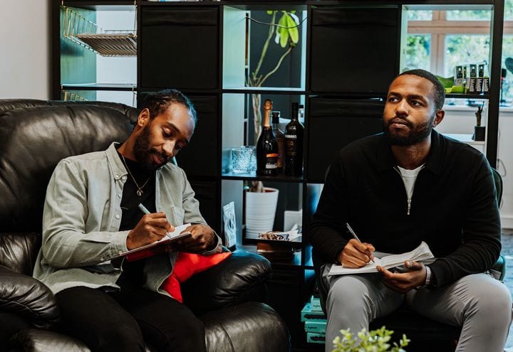 Two 21 Degrees team members taking notes during a session.